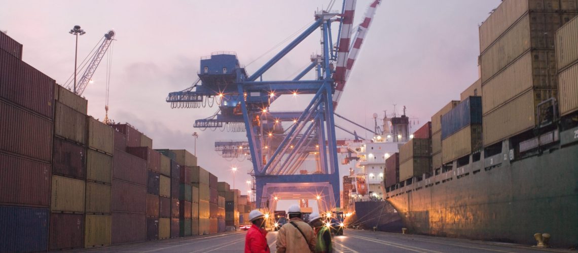 Workers talking in a shipping yard